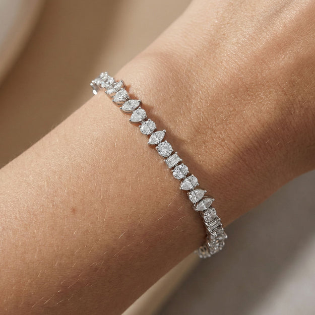 Diamond bracelet on a wrist with a neutral background